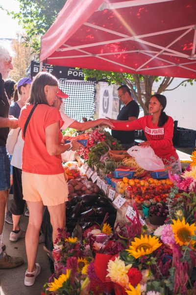 Customers at the Dane County Farmer’s Market buying vegetables, September 27, 2025.