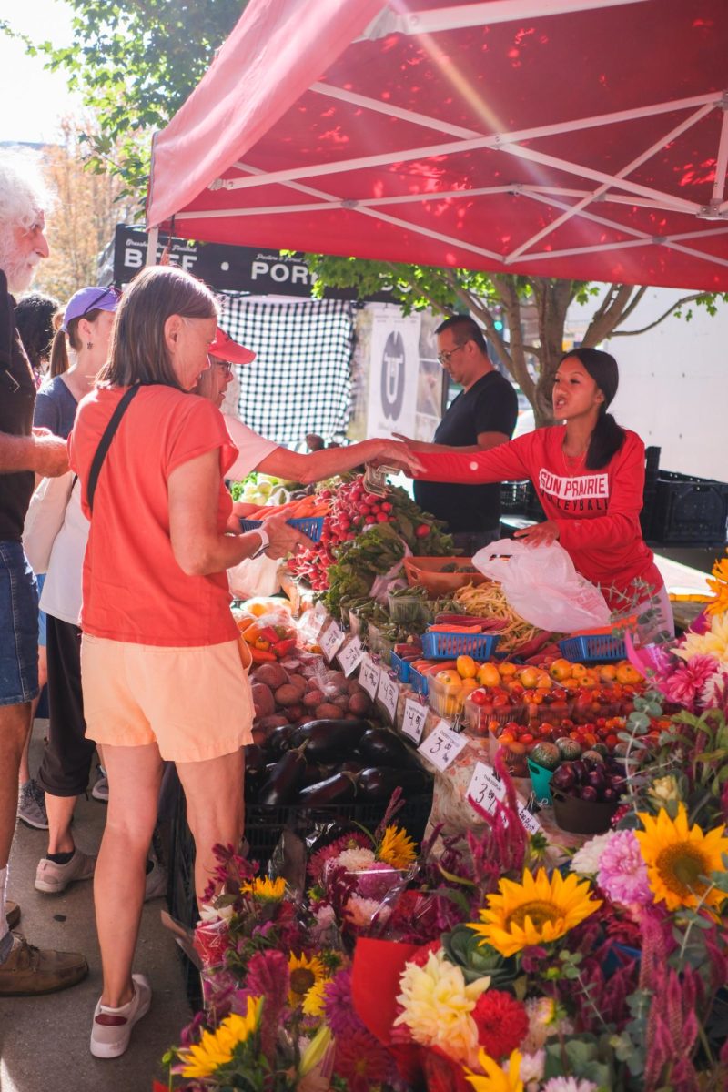 Customers at the Dane County Farmer’s Market buying vegetables, September 27, 2025.
