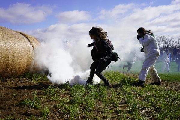 Protestor stamps out tear gas canister on Ridglan Farms property. April 18, 2026.
